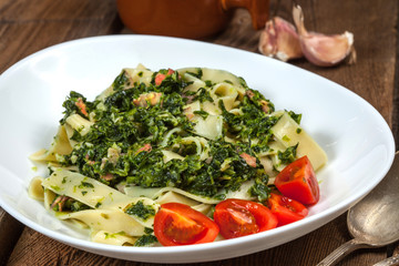 Spaghetti with spinach and bacon.