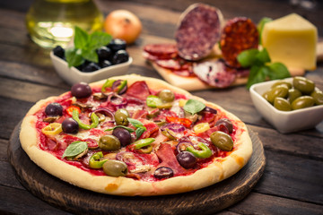 Homemade pizza with ham, cheese and vegetables