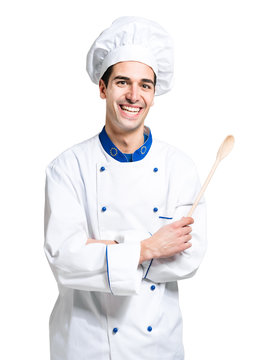 Young smiling chef isolated on white holding a spoon