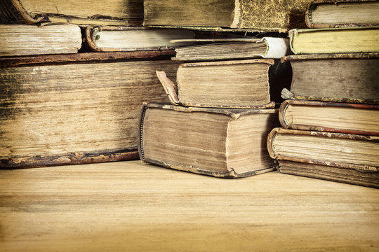 Sepia toned image of old books on a table