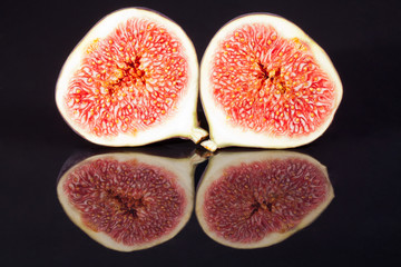fruits of sectioned fresh figs isolated on black  background