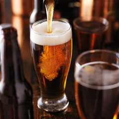 verser de la bière dans un verre sur une table en bois