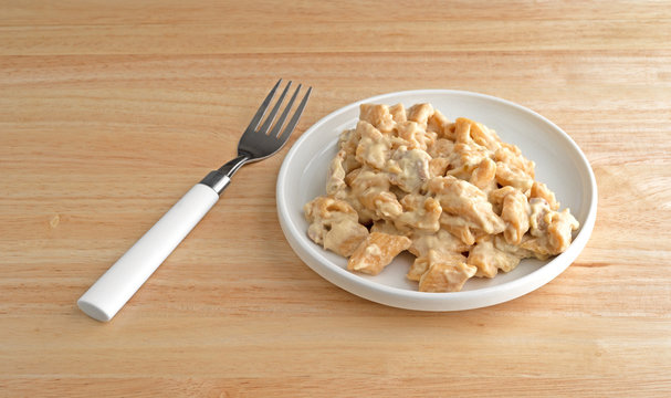 Chicken with pasta in jalapeno sauce on a wood table