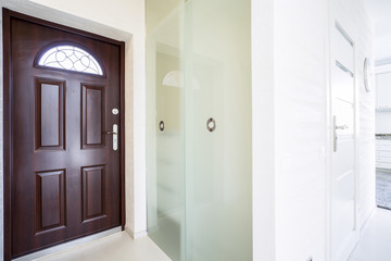 Huge wooden entrance door inside apartment