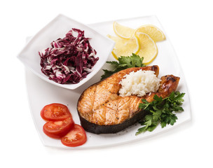 Grilled trout with vegetables and rice on a white background