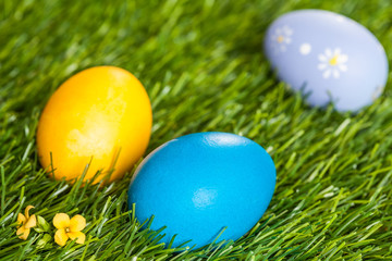 Obraz na płótnie Canvas Three Easter Eggs on Grass