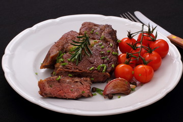 Rib eye steak, cherry tomatoes, garlic, herbs