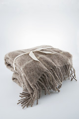 Wool blanket tied with a ribbon..