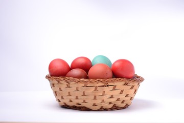 Obraz na płótnie Canvas Colored easter eggs in basket. White background.