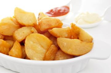 typical spanish patatas bravas, fried potatoes with a hot sauce