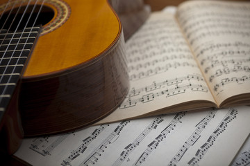 The concept of musical notes and guitar in the background