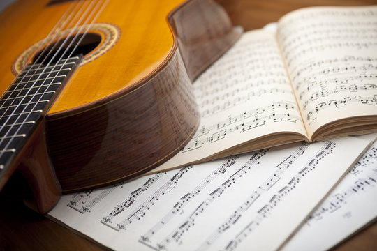 The concept of musical notes and guitar in the background