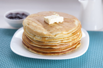 Delicious sweet American pancakes on a plate with fresh fruits