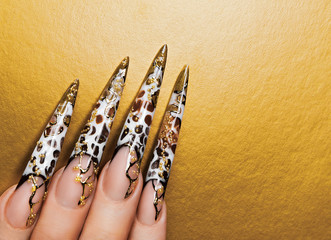 Art design  nails on gold background.