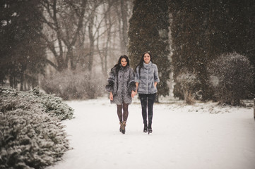 Fototapeta na wymiar funny girls enjoying winter weather