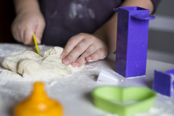 Child hands playing with dough