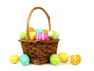 Easter basket filled with colorful eggs on a white background - Powered by Adobe