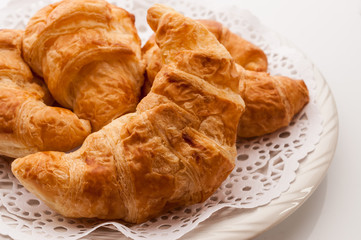 fresh croissants on wooden table