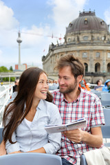 Fototapeta premium Tourists couple reading travel book on Berlin boat