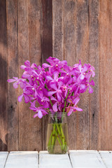 Beautiful bouquet of orchids flower on a wooden background