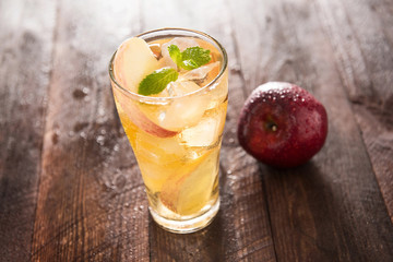 apple juice and apples on wooden table