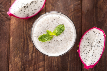 Top dragon fruit smoothie on wooden table