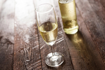 Glass of white wine on wooden table
