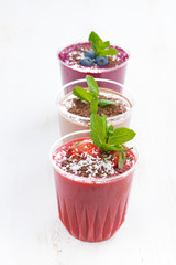 strawberry, blueberry and chocolate milkshakes in glasses