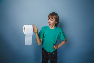 European-looking  boy of ten  years with  toilet paper on a gray