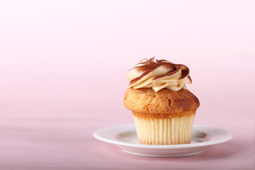 cupcake with frosting on white plate
