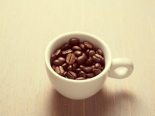 Coffee crop beans in white espresso cup