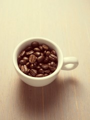 Coffee crop beans in white espresso cup
