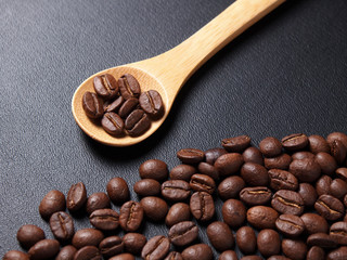 Fototapeta premium Coffee crop beans on bamboo spoon and leather texture