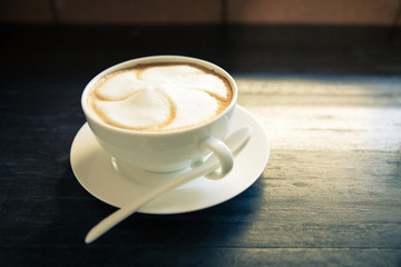 Cappuccino cup with white spoon.