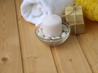Towel,soap,candle and sponge on the wooden background