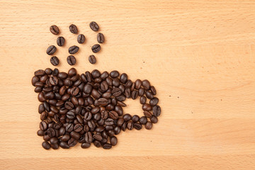 Roasted coffee beans in coffee cup shape