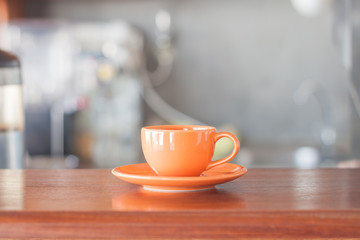 Mini oange coffee cup in coffee shop