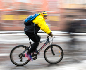 Fototapeta premium Man on bicycle in the city in a winter day