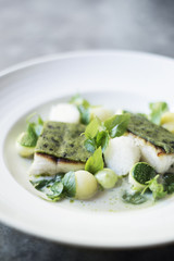 fish fillet with herb topping and vegetables