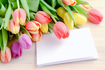 Springtime decoration with tulips and white note paper copy spac