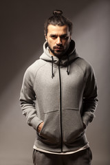 young man with beard and bun in tracksuits