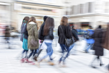 A shopper walking past a store window