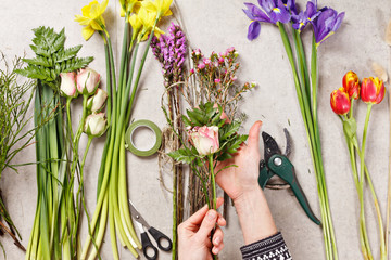 hands of florist making bouquet spring flowers - 78693053