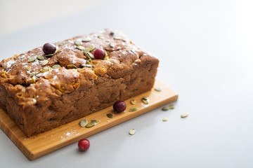 Closeup on freshly baked pumpkin bread with seeds on table