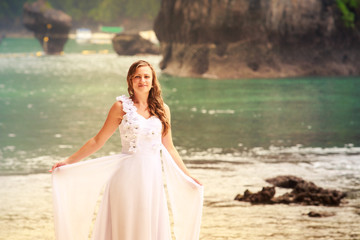 Fototapeta na wymiar young blonde girl demonstrates her wedding dress
