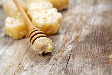 Honey with comb on wooden table