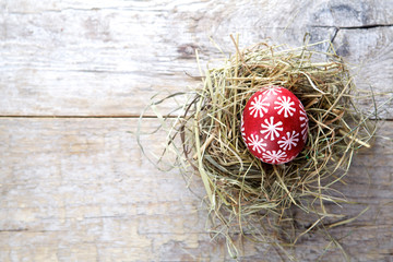 Easter decorations. Eggs in nests on wooden background