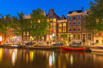 Fototapeta na wymiar Night city view of Amsterdam canal with dutch houses
