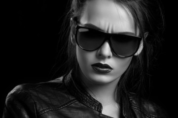 black and white photo of the girl in a jacket and sunglasses