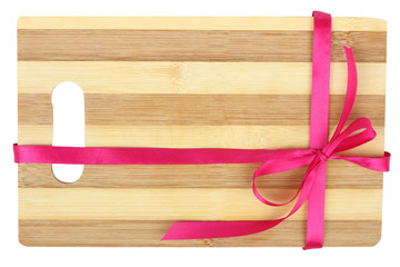 wooden cutting board with a ribbon on a white background